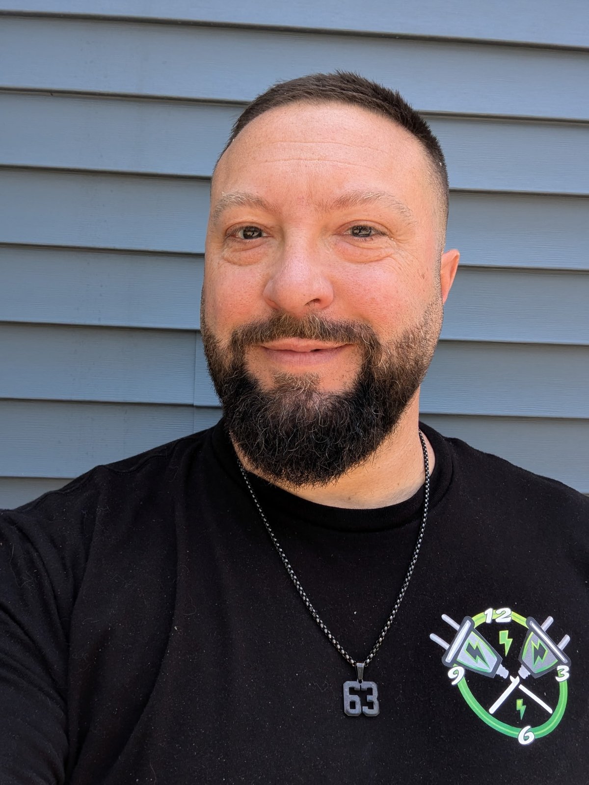 Matt Albrycht, owner of Down To The Wire LLC, wearing a company-branded shirt with the electric green logo.