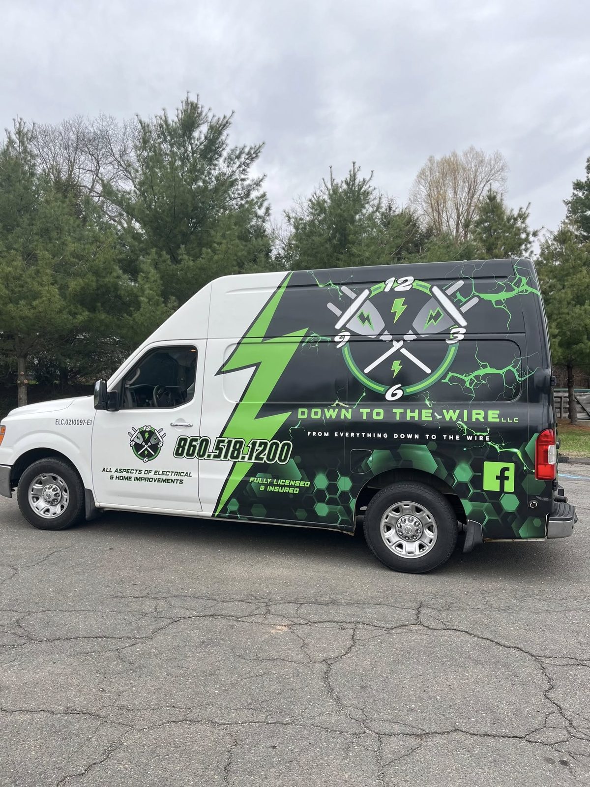 Down To The Wire LLC service van wrapped in black with electric green lightning bolt graphics